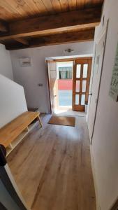 an empty room with a wooden table and a door at La Encina del Abuelo in La Adrada