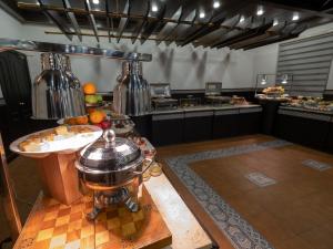 a large kitchen with a table with food on it at Amman West Hotel in Amman