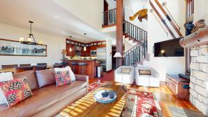 a living room with a couch and a table at Juniper Crest #24 townhouse in Mammoth Lakes +70 photos