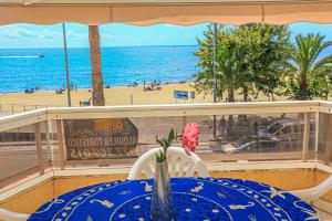 a table on a balcony with a view of the beach at Austral - ONLY FAMILIES in Cambrils