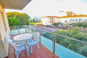 a balcony with a table and chairs on a balcony at Sol Millet Litoral - ONLY FAMILIES in Cambrils