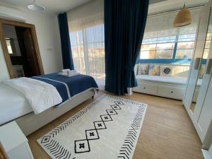 a bedroom with a bed and a rug on the floor at Detached villa in Alaçatı… in Alacati