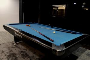 a pool table with two cue balls on it at Mirage Hotel in Dibba