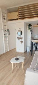 a living room with a table and a couch at Casa Mar, studio 4P, vue mer, Sant'Ambroggio, Lumio in Lumio +11 photos