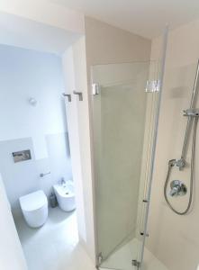 a bathroom with a shower and a toilet at Dione Apartments by Dimore in Sicily Ortigia in Siracusa +31 photos