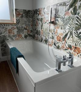 a bathroom with a bath tub with a sink at Marshpools Bed & Breakfast - Licensed near Weobley village in Weobley