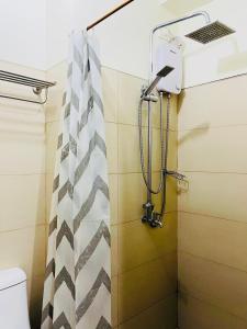 a shower in a bathroom with a shower curtain at Wind Suites Tagaytay at SMDC in Tagaytay