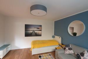 a bedroom with a bed and a mirror at Apartment_BaLi in Linkenheim-Hochstetten