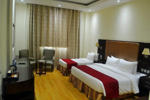 เตียงในห้องที่ Palm Inn Hotel Doha