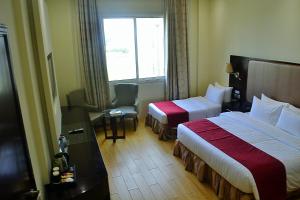 เตียงในห้องที่ Palm Inn Hotel Doha