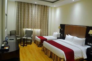 เตียงในห้องที่ Palm Inn Hotel Doha