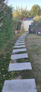 a stepping stone path in a grass field at Nid de verdure à 15 minutes centre et plage in Le Havre