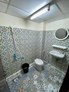 a bathroom with a toilet and a sink at Ratanawong Place 801 in Bangkok +12 photos