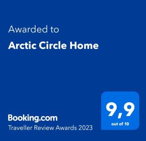 a blue sign with the text awarded to arctic circle home at Arctic Circle Home in Rovaniemi
