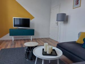 - un salon avec un canapé et une télévision dans l'établissement Stadthaus mit Dachterrasse, à Varel