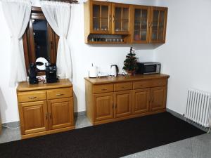 a kitchen with wooden cabinets and a christmas tree on the counter at Casa Sandu-Sadova in Sadova