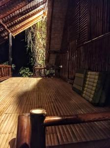 a large wooden deck with a bench on it at KRABI BAMBOO KINGDOM at AOLUEK PARADISE in Ao Luk