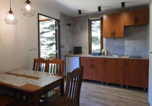 a kitchen with a table and a dining room at Farma Jantar in Jantar