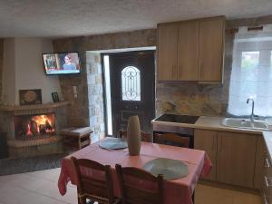 a kitchen with a table and a fireplace at Stymfalia stone house 