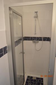 a shower with a glass door in a bathroom at LA VELA in Palmeira