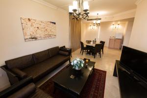 a living room with a couch and a table at Jerusalem Gardens Hotel in Jerusalem