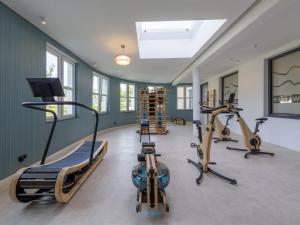 een fitnessruimte met drie loopbanden en drie hometrainers bij Meerblick mit Kamin am Saaler Bodden in Wustrow