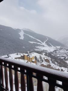 a view of a snow covered valley from a balcony at Soldeu Paradis Soldeu in Soldeu