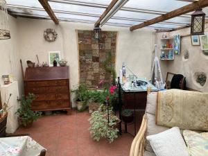 ein Wohnzimmer mit einem Sofa und einem Schreibtisch in der Unterkunft Little Reeds in Bovey Tracey