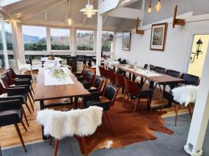 a dining room with tables and chairs with faux fur seats at Apartment Haus Pflingsteck nahe Europa Park Rulantica in Freiamt