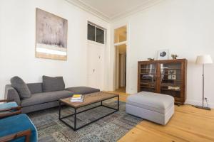 a living room with a couch and a coffee table at Santa Justa Prime Guesthouse in Lisbon