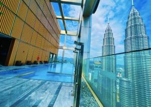 a view of the petronas twin towers from the observation deck of a building at Tropicana The Residences KLCC By Luxury Suites in Kuala Lumpur