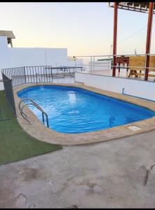a large swimming pool on the roof of a building at La Casa Blanca Departamento 1 in Coquimbo
