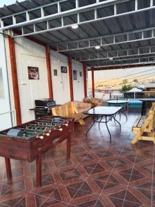 a room with a pool table and tables at La Casa Blanca Departamento 1 piscina temperada in Coquimbo