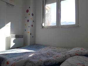 a bed in a bedroom with a window at Apartment Goran and Milena in Ohrid