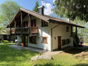 a white house with a balcony and a porch at Appartamenti Castagner in Pinzolo