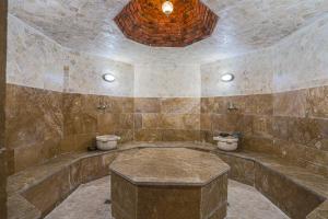 a stone bathroom with two toilets in a room at Knyazli Family Suites & Rooms in Kiçik Qaramurad +64 photos