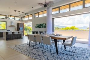 a dining room and kitchen with a table and chairs at Manta Cove by Horizon Holidays in Tamarin