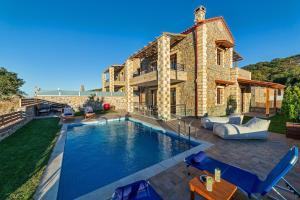 a house with a swimming pool in the yard at Asfendamos Villas in Zonianá