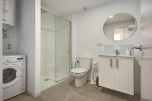 a bathroom with a toilet and a glass shower at Beds & Breaks - Marina Beach in Valencia
