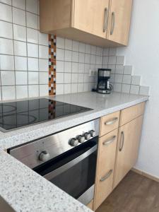 a kitchen with a stove and a counter top at Wohnung Magdalena in Feldkirchen in Kärnten