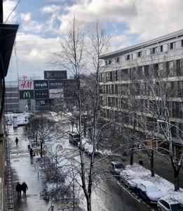 a city street with snow covered cars and buildings at Time for Cracow in Krakow