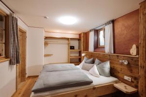 a bedroom with a bed with a wooden headboard at Babel´s Auszeit in Pfronten