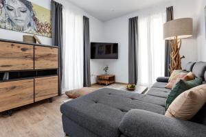 a living room with a couch and a tv at Pinzon Studios & Penthouse in Alicante