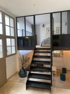a room with a staircase leading to a bedroom at Le loft Rousseau in Dijon