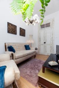 a living room with a couch and a table at Casa Dourada in Barcelos