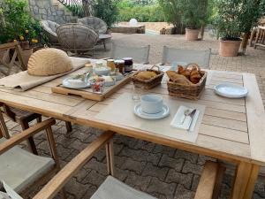a wooden table with food on top of it at Villa San Marco chambre d hôtes in Lorgues