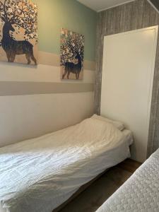 een slaapkamer met 2 bedden en 2 schilderijen aan de muur bij Apartment at the Beach in Noordwijk +14 foto's