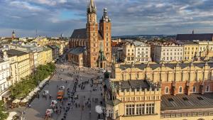 an aerial view of a city with a clock tower at Time for Cracow in Krakow