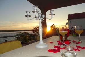 a table with a candle and a glass of wine at Apartment Seaview, Rtina in Rtina
