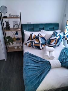 1 cama con almohadas coloridas en el dormitorio en Stylish London Studio l 1 Bd, 1 Bath Urban Retreat en Londres